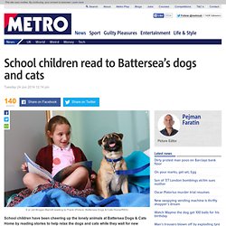 School children read to Battersea Dogs & Cats Home's furry residents
