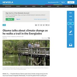 Obama talks about climate change as he walks a trail in the Everglades