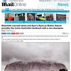 Ayers Rock pictured in rare storm as half a years rain falls in one day