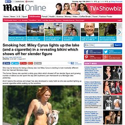Miley Cyrus lights up the lake (and a cigarette) in a revealing bikini which shows off her slender figure