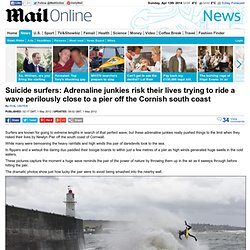 Suicide surfers: Adrenaline junkies risk their lives trying to ride a wave perilously close to a pier off the Cornish south coast